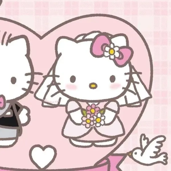 Có hai cô dâu hello kitty đứng trước trái tim
