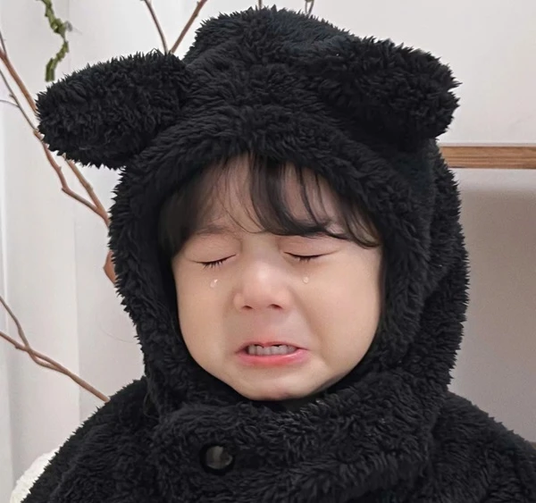 Một cậu bé mặc trang phục gấu đen crying meme