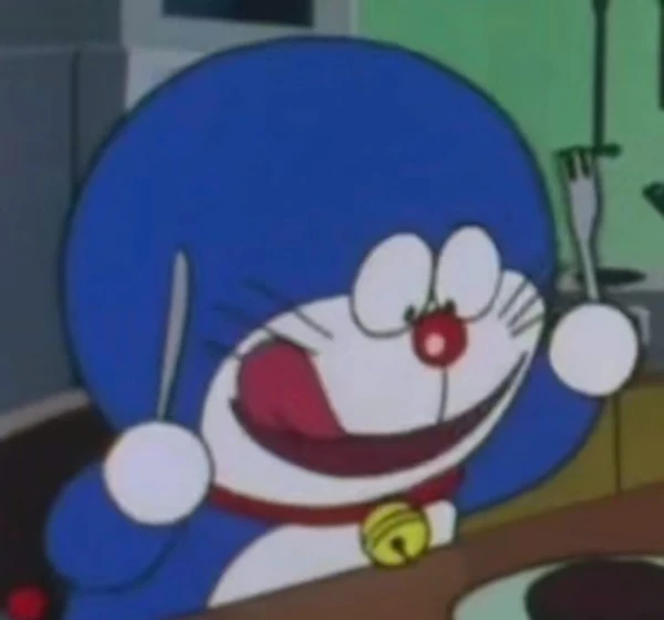 một nhân vật hoạt hình với khuôn mặt màu xanh và mũi đỏ meme doraemon