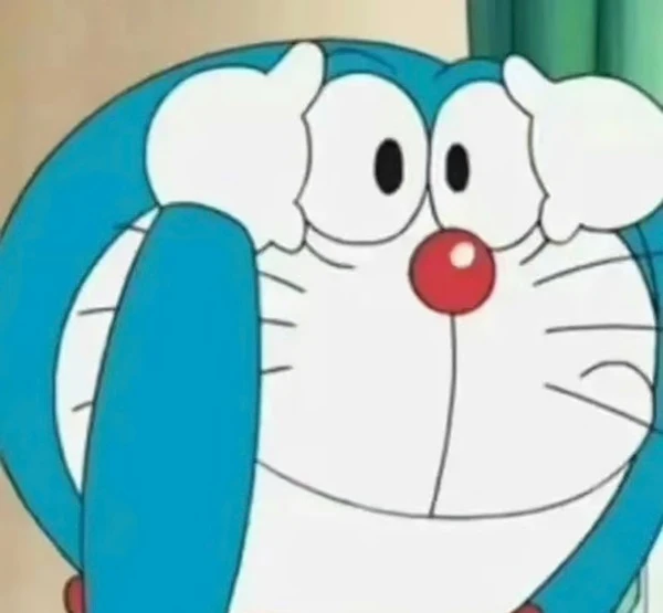 một nhân vật hoạt hình với khuôn mặt màu xanh và trắng meme doraemon