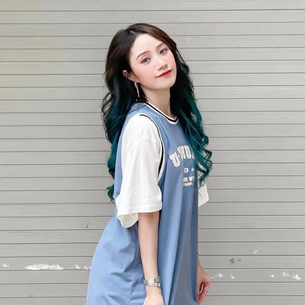 Đào lê phương hoa có một phụ nữ trẻ với mái tóc xanh đứng trước tường