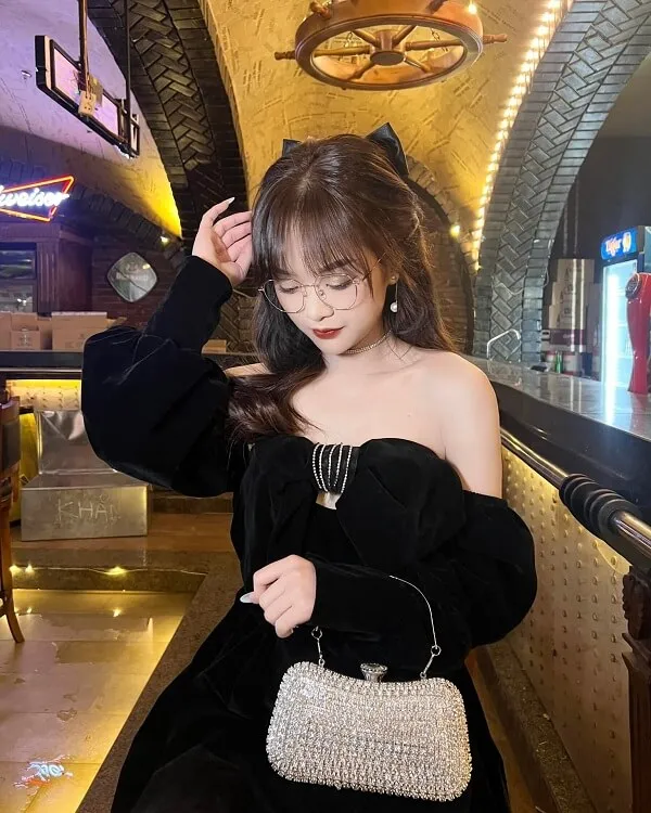 Ảnh sex gấm kami có một người phụ nữ đang ngồi trên chiếc ghế dài với ví