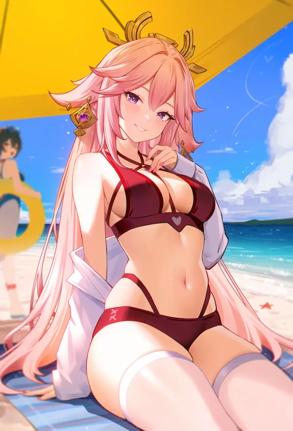 Ảnh miko bikini có một người phụ nữ mặc ngồi trên bãi biển