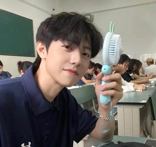 Ảnh trai cute có một người đàn ông đang cầm bàn chải đánh răng trong tay