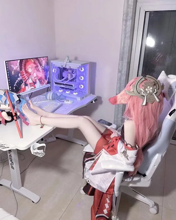 Ảnh yae miko cute có một người phụ nữ đang ngồi trước máy tính