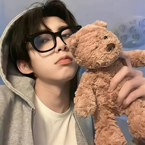 There is woman that holding teddy bear in her hands