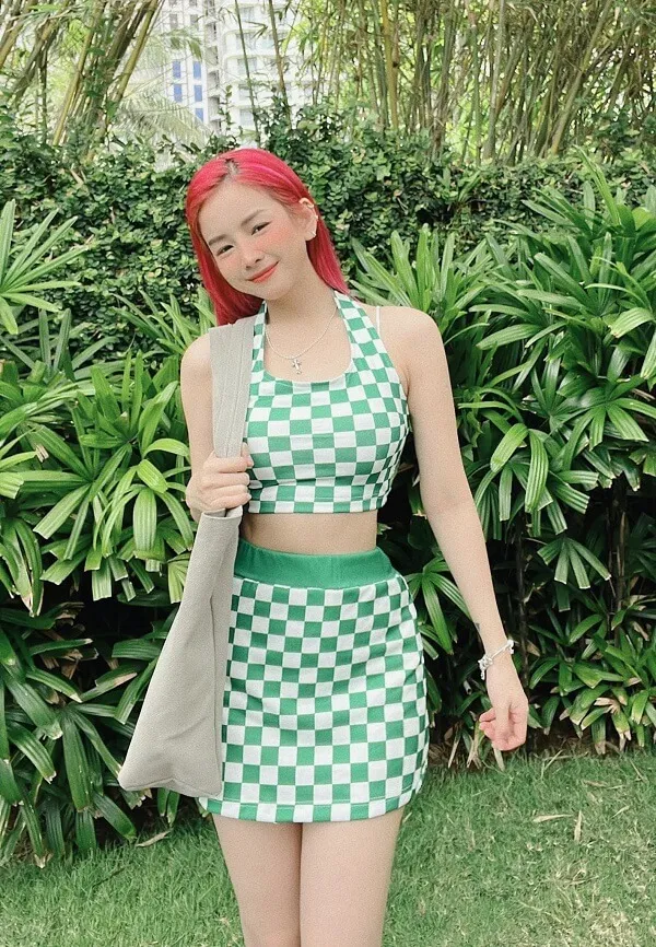 Dj mie có một người phụ nữ mái tóc đỏ mặc áo choàng màu xanh lá cây và trắng